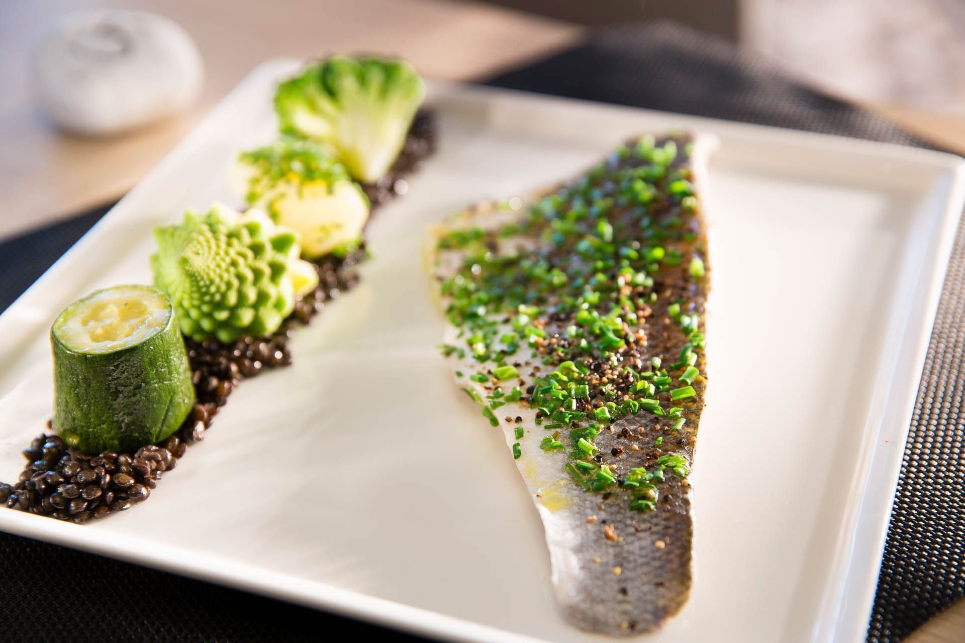 Close-up of a well garnished fish dish at Oceania Rennes
