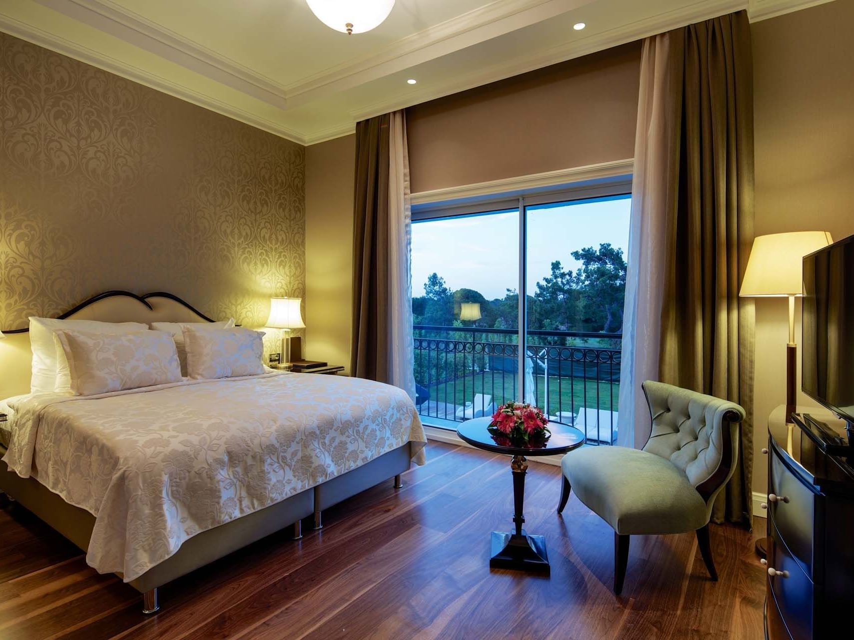 Cozy bed and sitting area with the outside view in a room at Titanic Deluxe Golf Belek