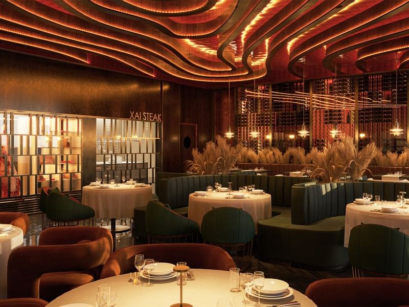 Elegante restaurante Llumea Steak en Fiesta Americana Funeeq Punta Cana con techo ondulado de madera y luz cálida