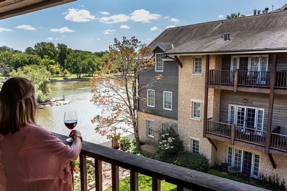 Lady holding wine glass on a balcony, The Herrington Inn & Spa