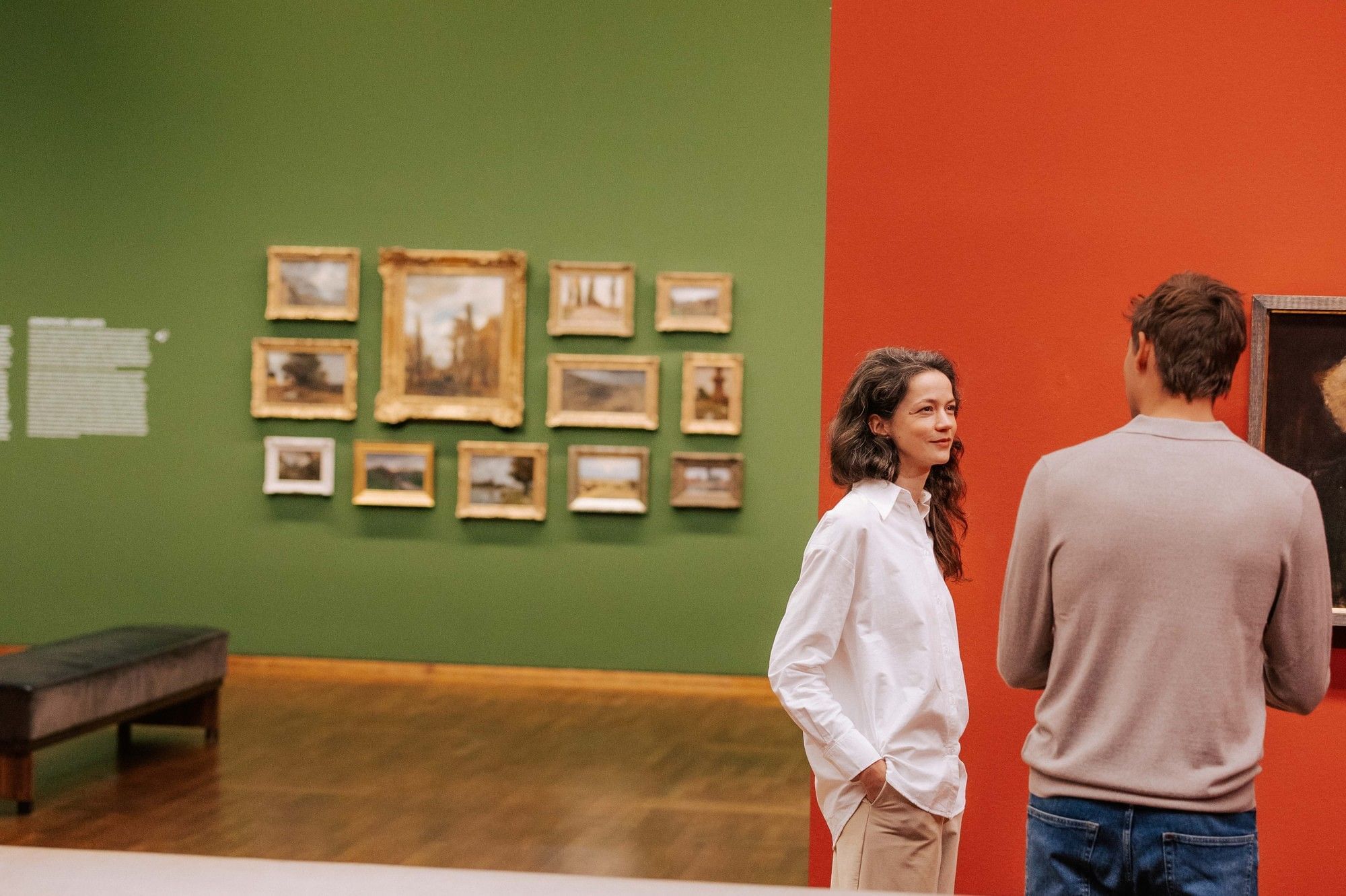 Museum visit in Vienna with two people viewing paintings in a modern exhibition setting