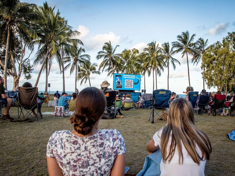 Two girls watching a movie at an outdoor cinema