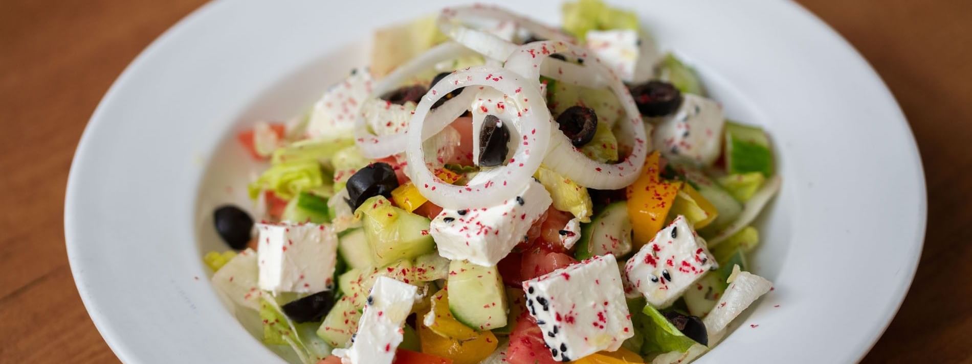 Fresh salad featuring diced cucumber, onion rings, and feta cheese in Seasons Restaurant at Warwick Hotel Jeddah
