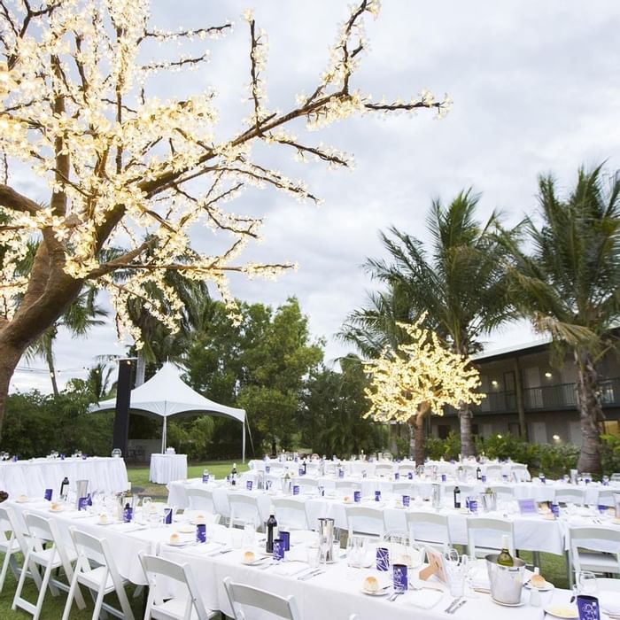 Outdoor wedding dining set up with white table and chairs at Mercure Hotel Townsville