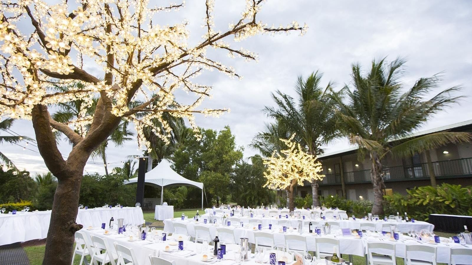 Outdoor wedding dining set up with white table and chairs at Mercure Hotel Townsville