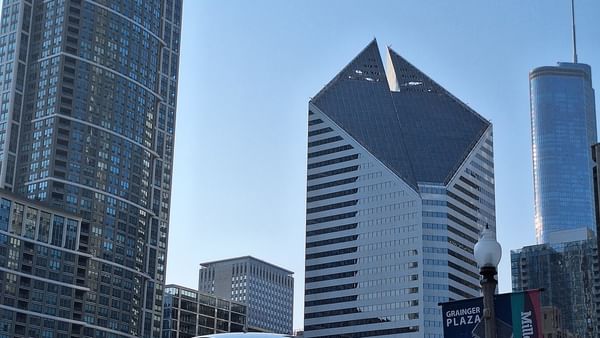 Millennium Park with a large reflective sculpture and many people at the center.