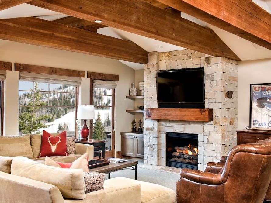 Living area with seating and fireplace in Luxury Suite at Chateaux Deer Valley