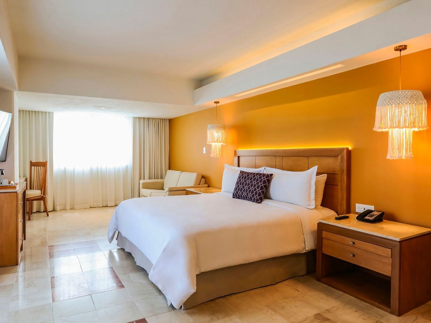 King Junior Suite with a plush king bed, stylish lamps, and a comfortable sofa area at Camino Real Veracruz
