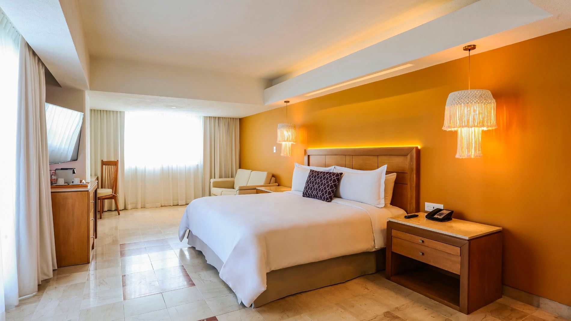 King Junior Suite with a plush king bed, stylish lamps, and a comfortable sofa area at Camino Real Veracruz