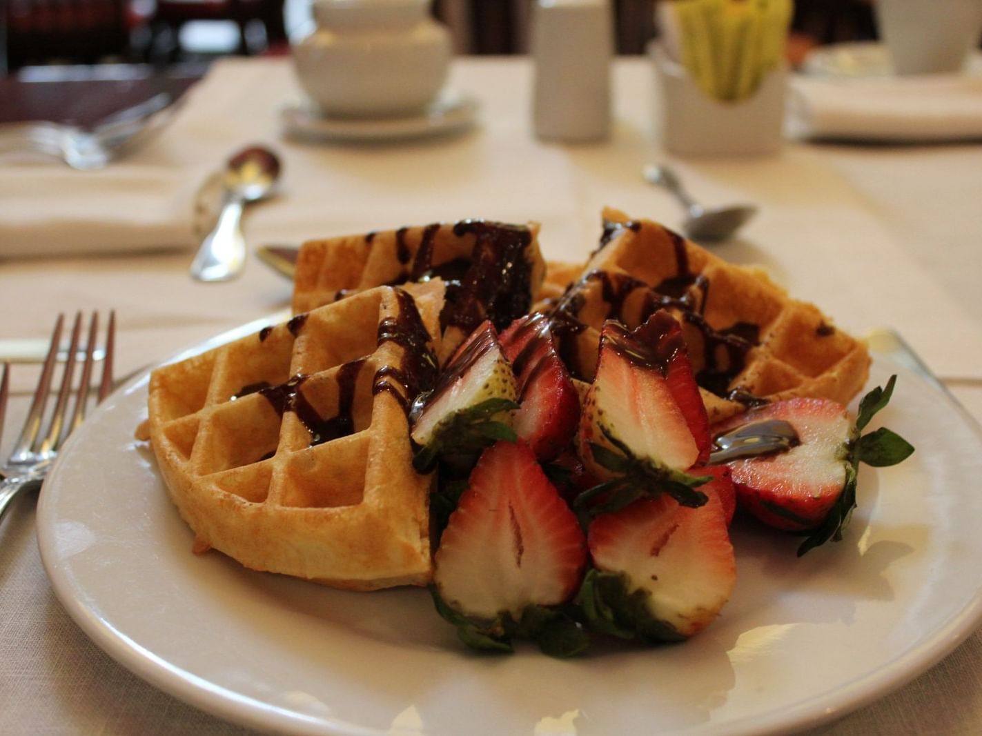 waffles and strawberries drizzled with chocolate