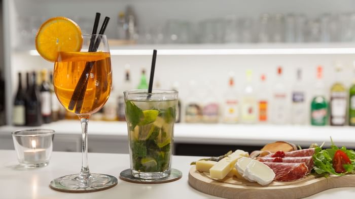 Two glasses of drinks with snack plate served at Hotel le loui.