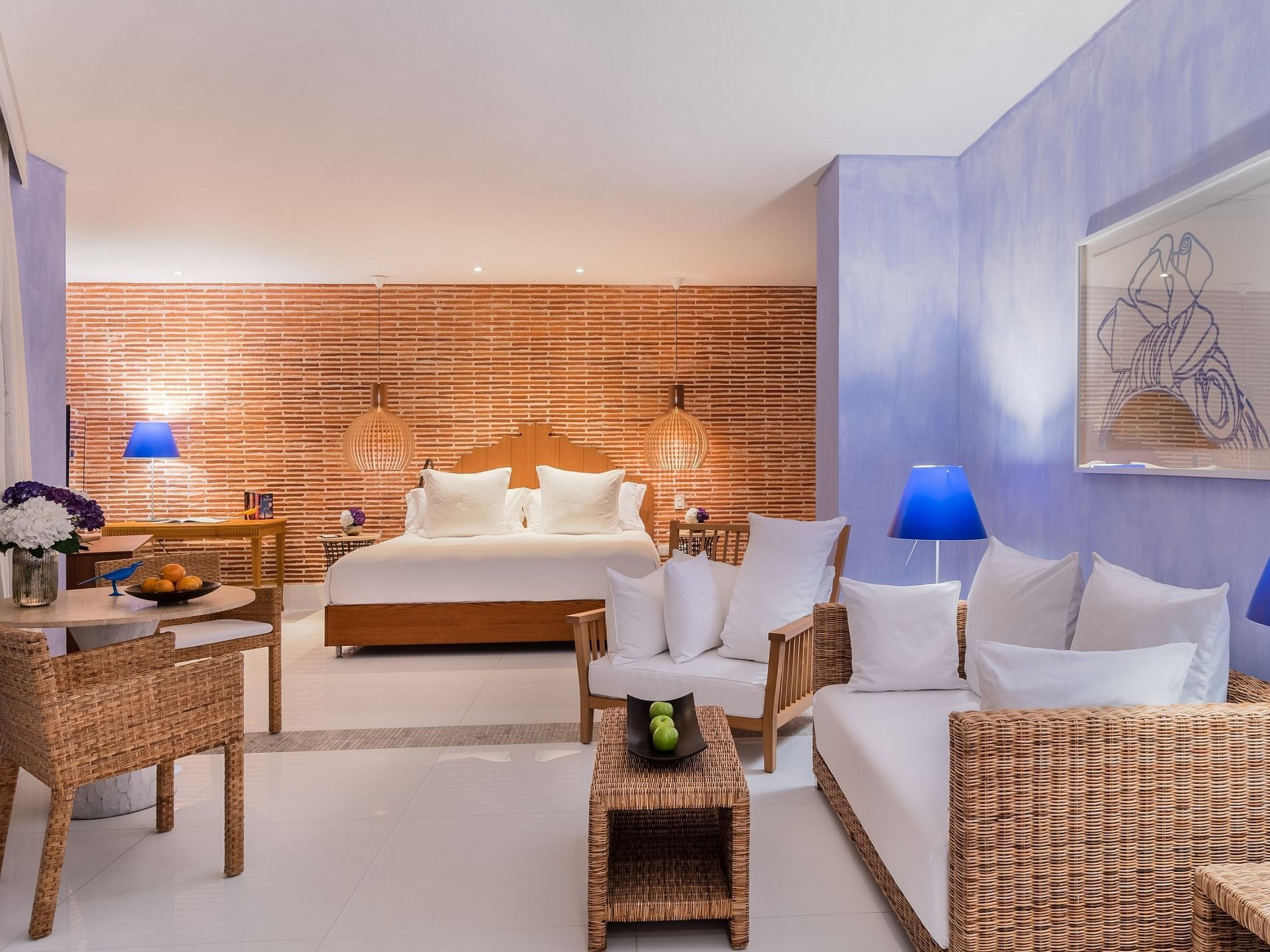 The Master Suite with Ocean View bedroom at Charleston Santa Teresa Cartagena with a bed, wicker couch, table, and chairs