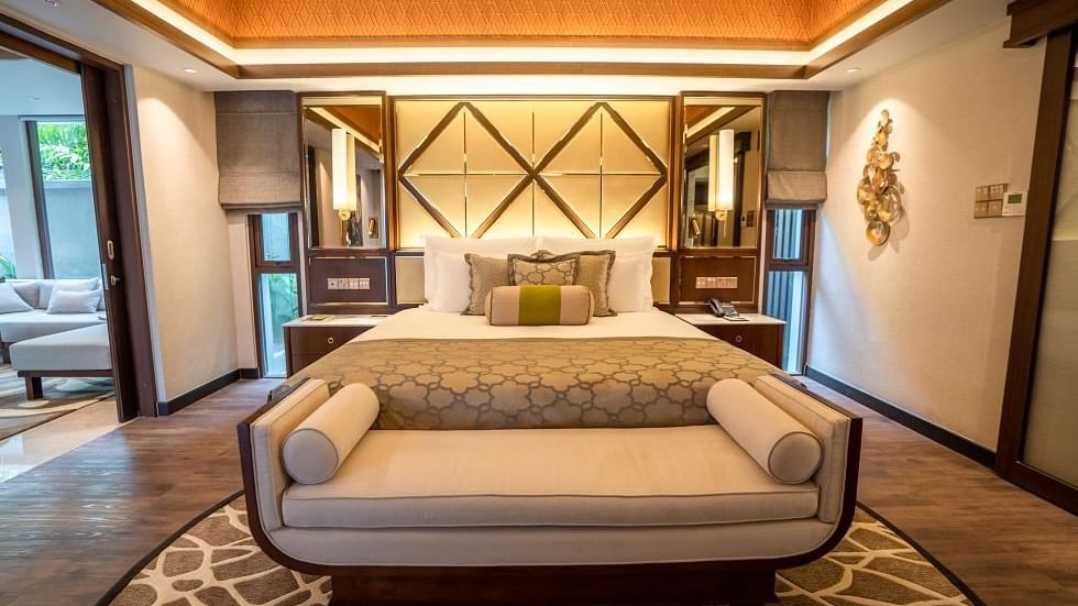 Spacious Royal Villa bedroom with geometric headboard, plush bedding, and elegant daybed at The Banjaran Hotsprings Retreat
