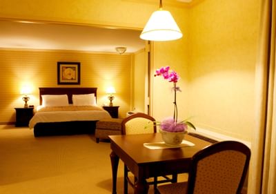Bed with dining table in VIP Suite at Honor’s Haven Retreat