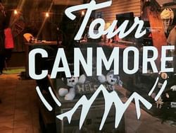 Tour Canmore sign featured on a glass door near Acclaim Hotel Calgary