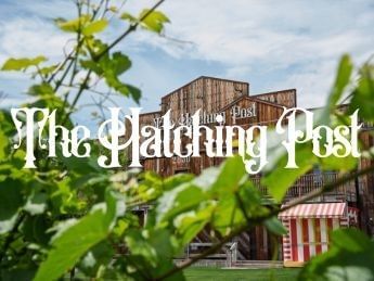 The Hatching Post logo over a rustic building and green foliage.