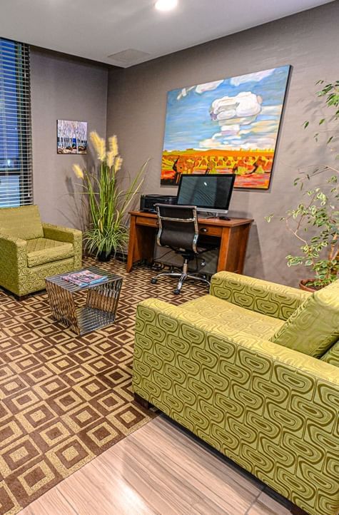 Interior view of a meeting room with a working desk at Encore Suites Grande Prairie