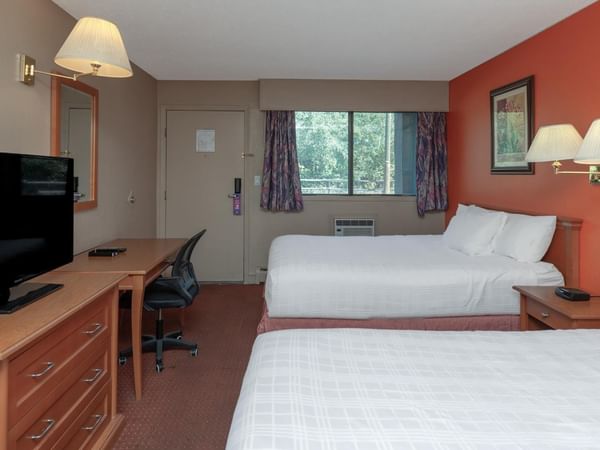 Guest room at Coast Red Deer Hotel with two queen beds and TV