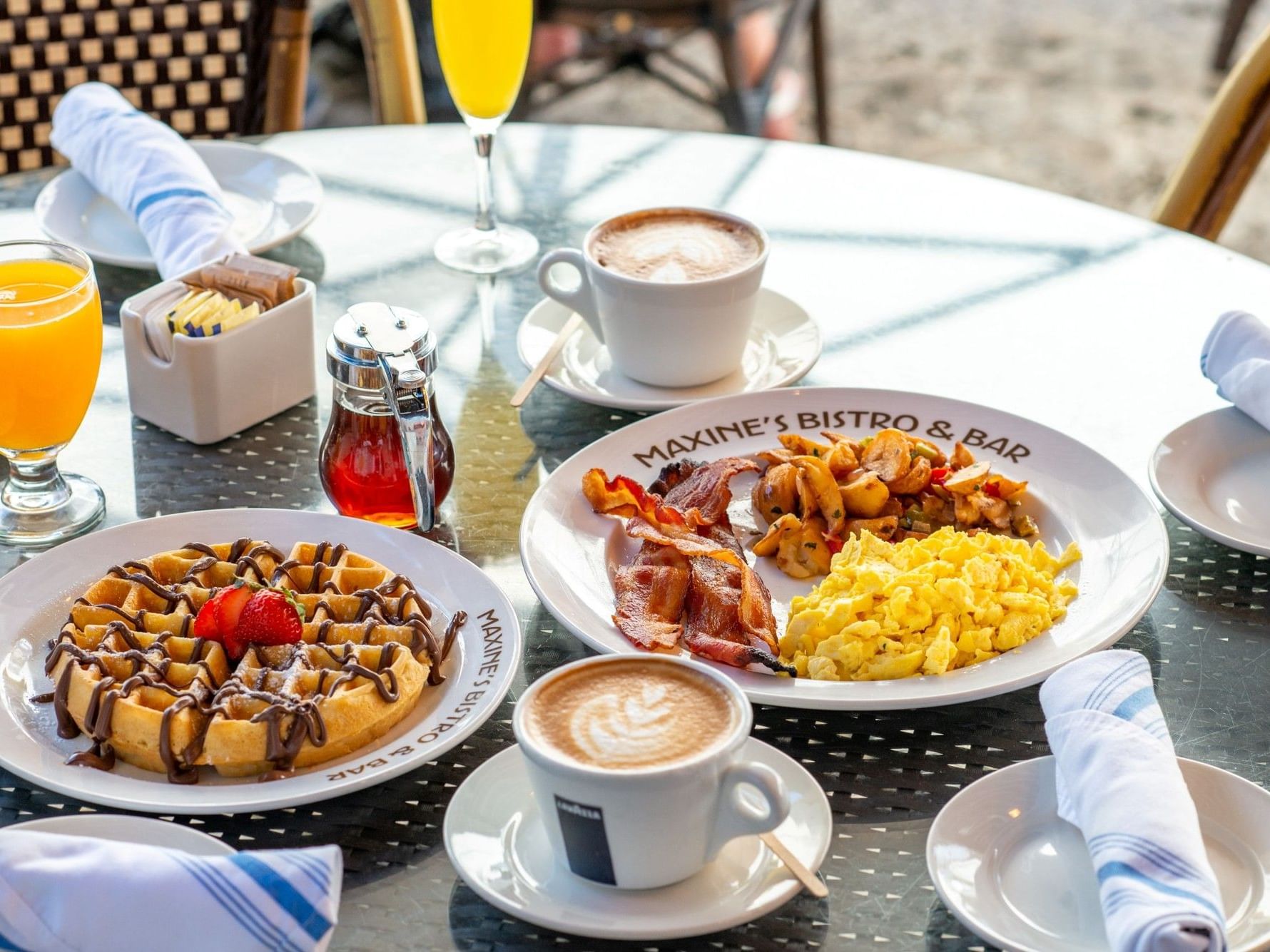 A table with a delicious breakfast spread at Maxine's Bistro & Bar near Tradewinds Apartment Hotel