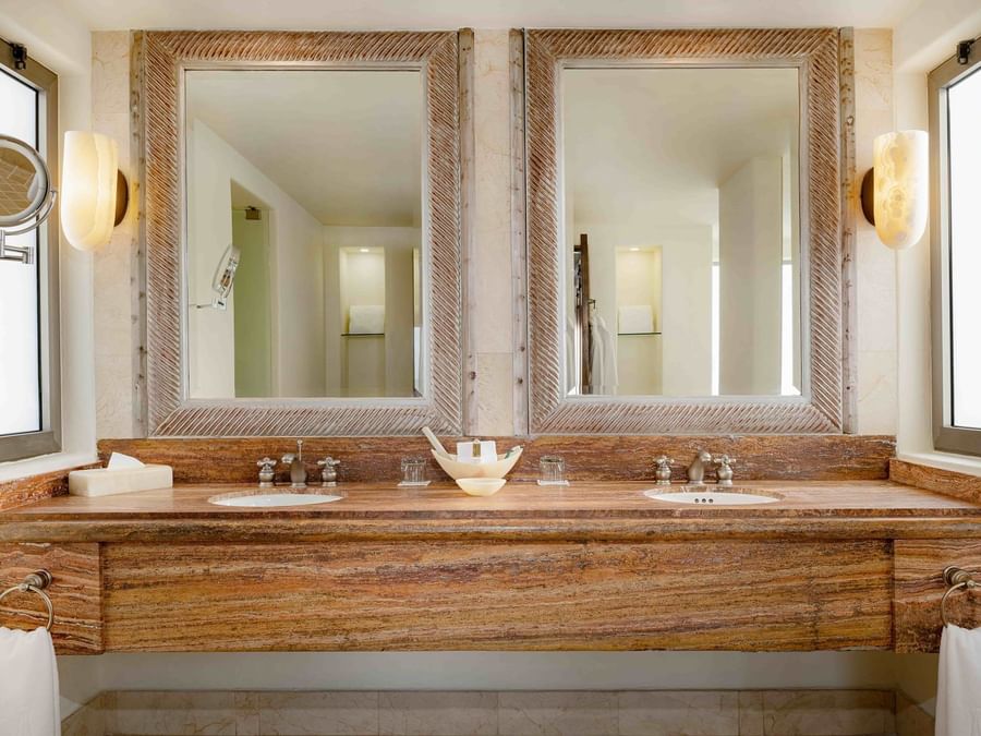 Modern bathroom vanity area at Casita Oceanfront in Marquis Los Cabos Resort featuring dual sinks and two mirrors