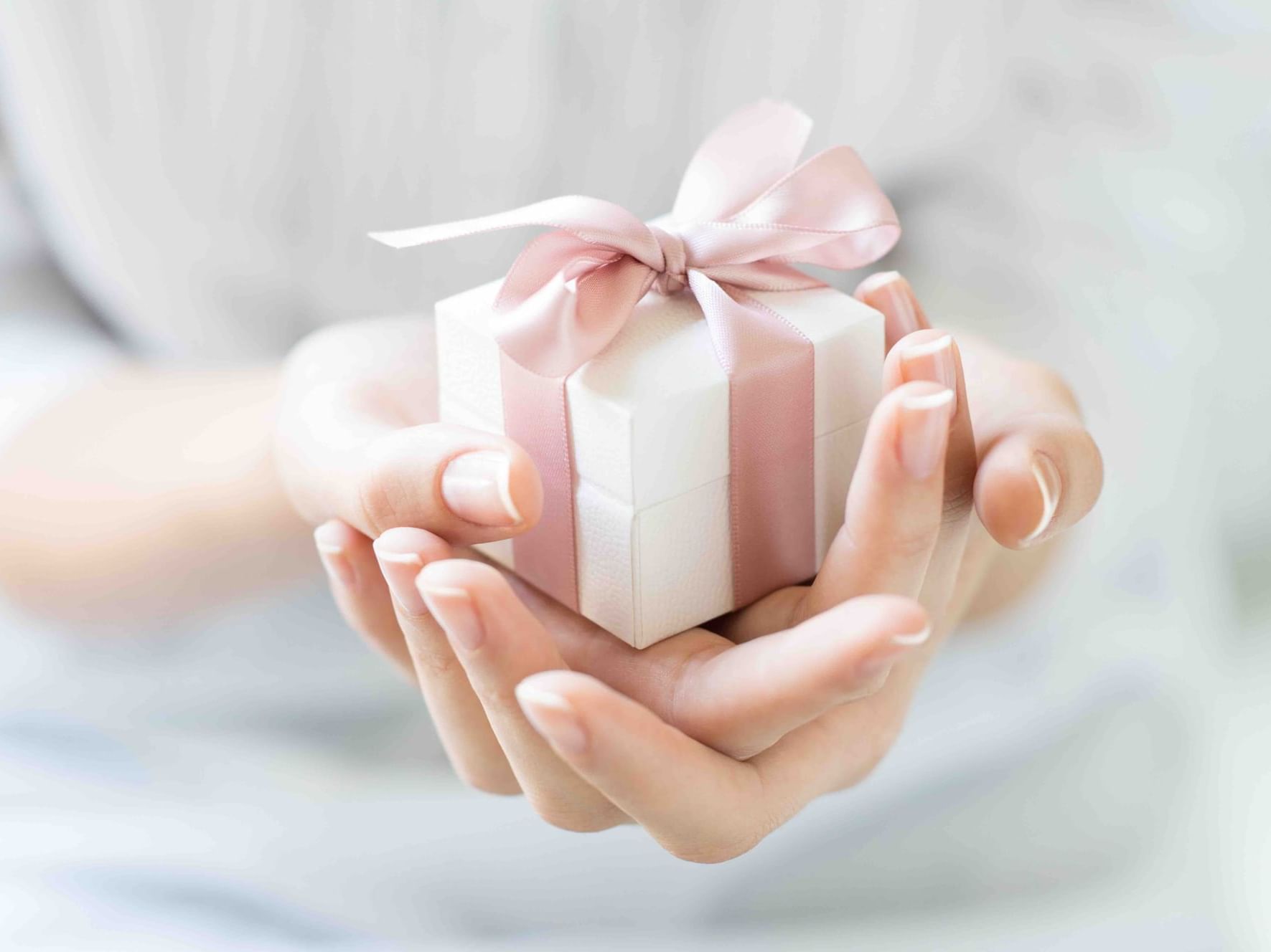 A girl holding a gift box at Danna Langkawi Hotel