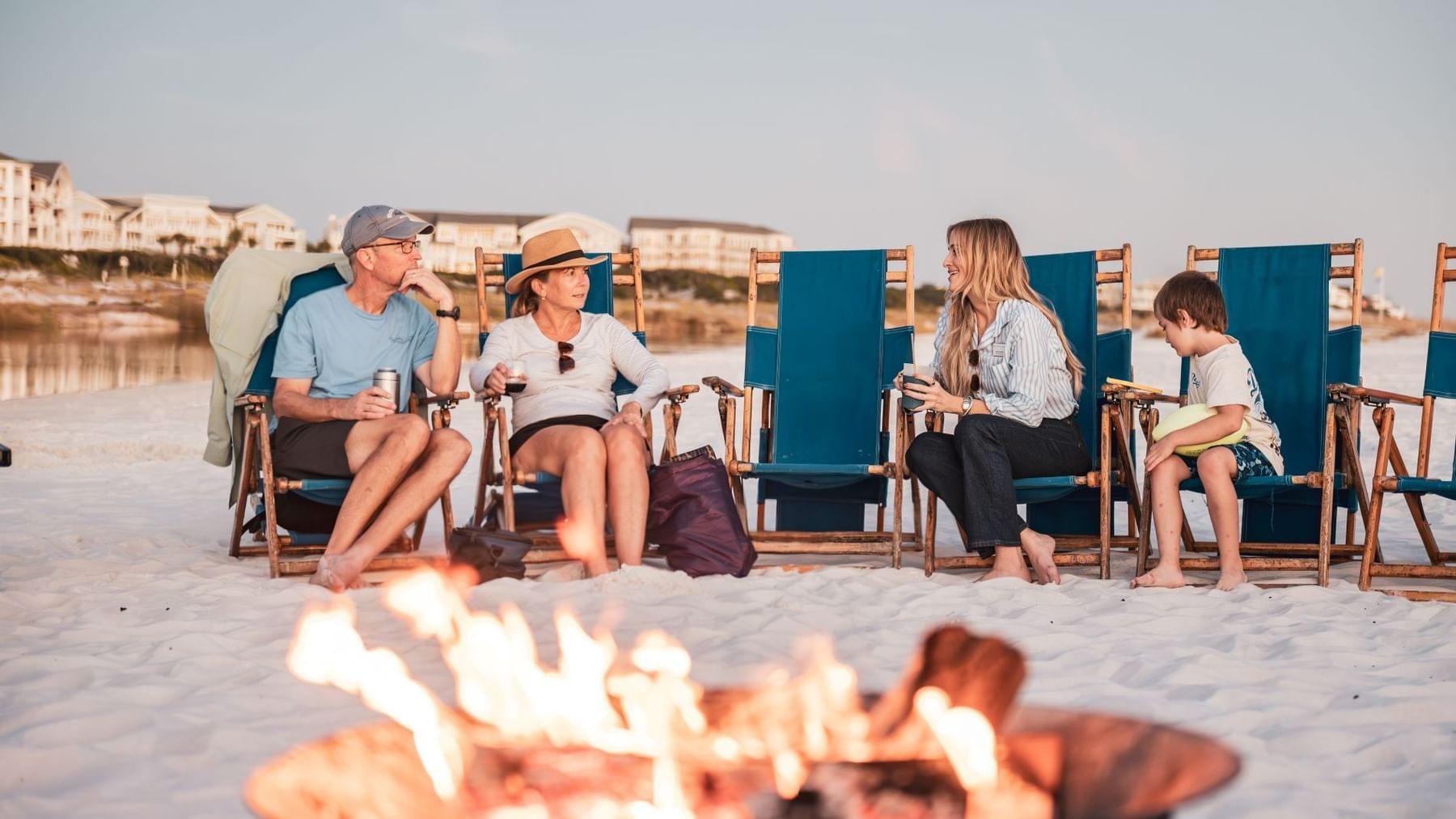 Family enjoying bonfire at Discover Watersound Weekend event.