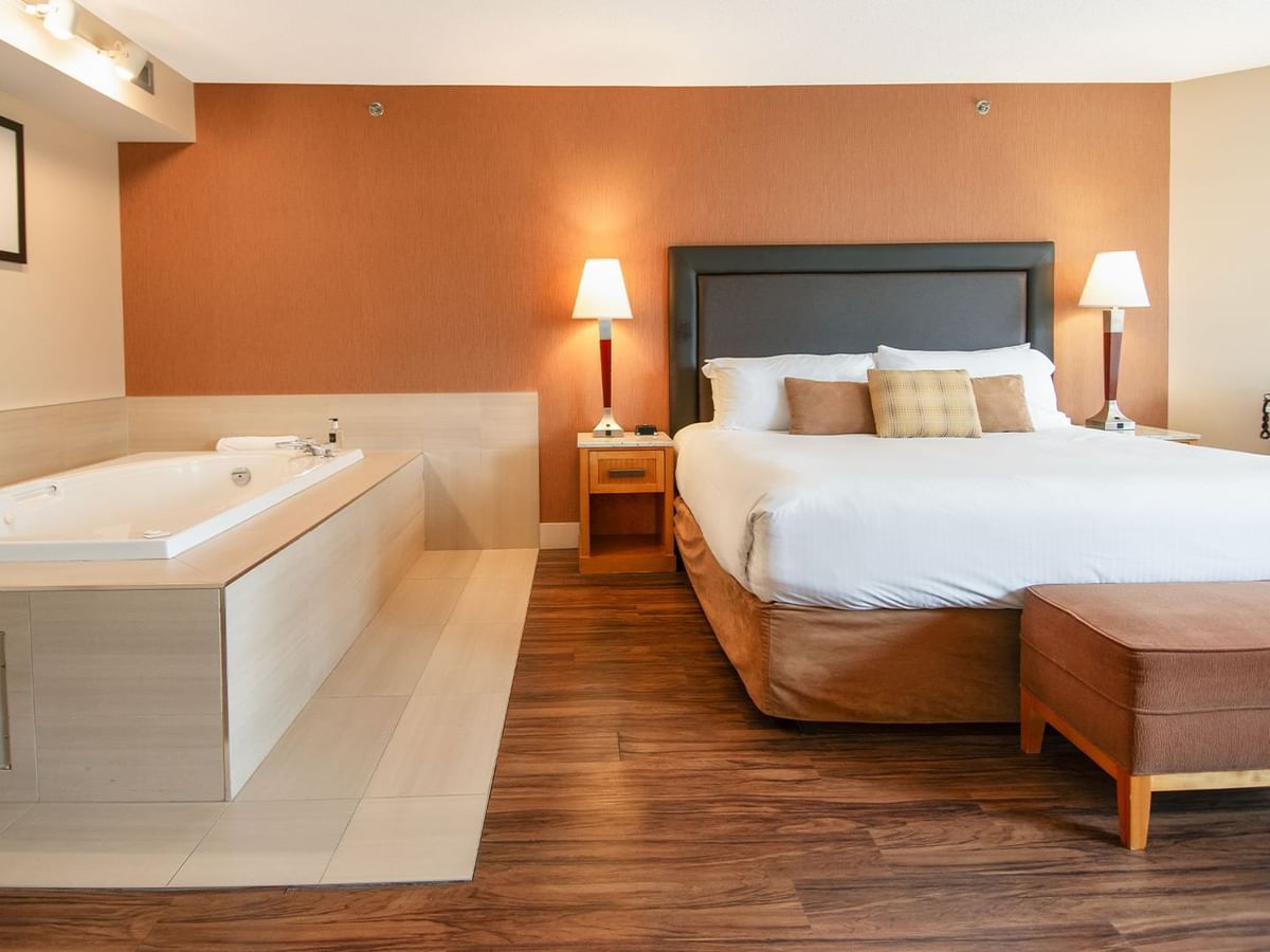 Hotel suite with king bed and jetted tub