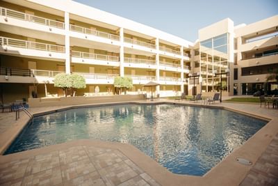 Outdoor pool area with loungers at Araiza Hotel Hermosillo