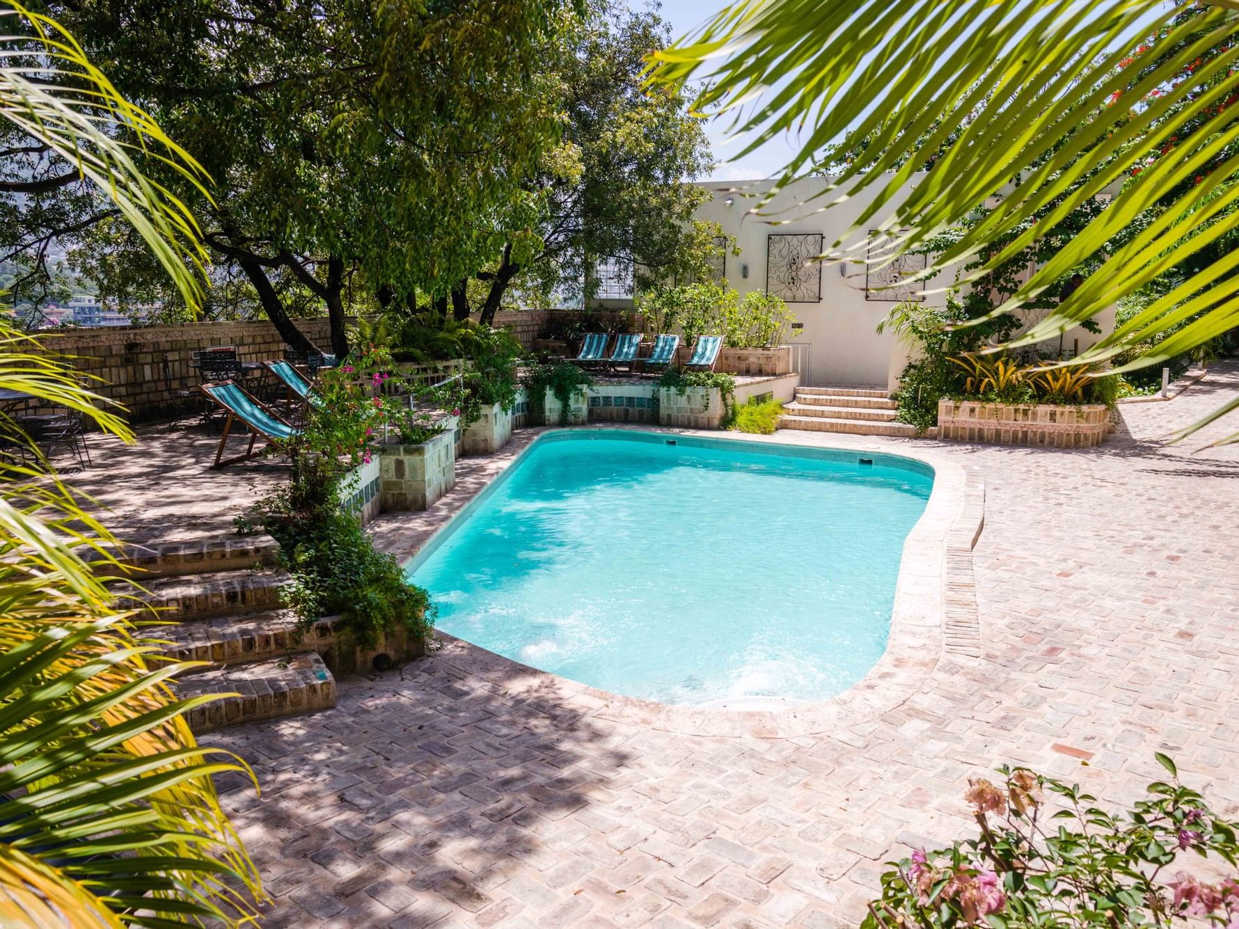 Lounges by the pool area in Ganac Room at Hotel Montana Haiti