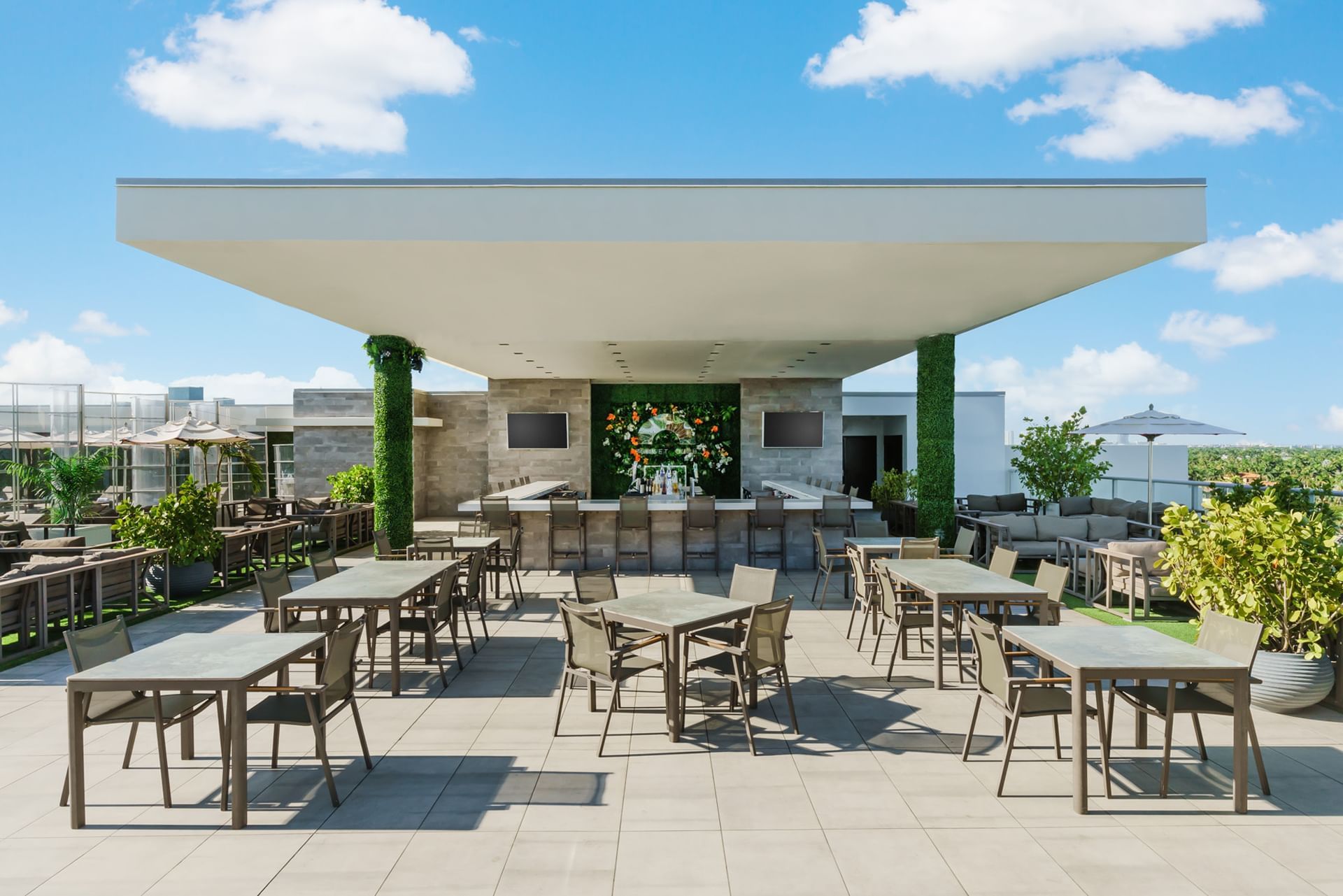 A covered outdoor bar area with seating and a bar.