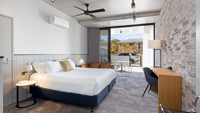 classic room bed and balcony view from kitchenette