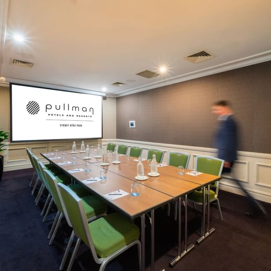 Boardroom set-up with projector screen in Dalley Room at Pullman Sydney Hyde Park