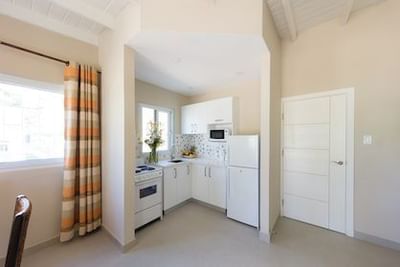 Modern kitchen with white appliances and curtains in Standard Suite at All Seasons Resort Europa