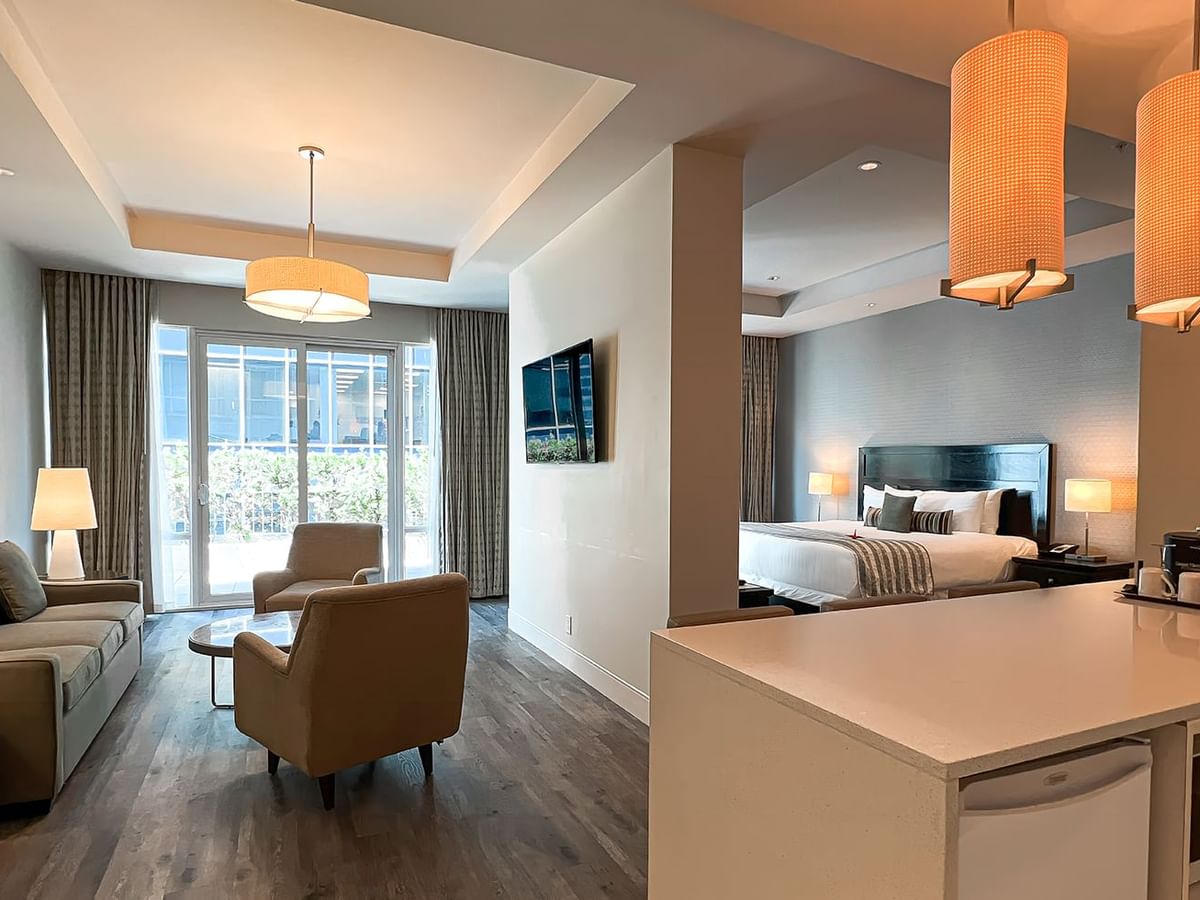 Coast Premium King Balcony & View room with sitting area, TV, lamps, and bed