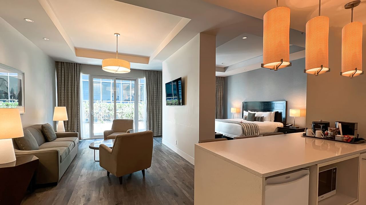 Coast Premium King Balcony & View room with sitting area, TV, lamps, and bed