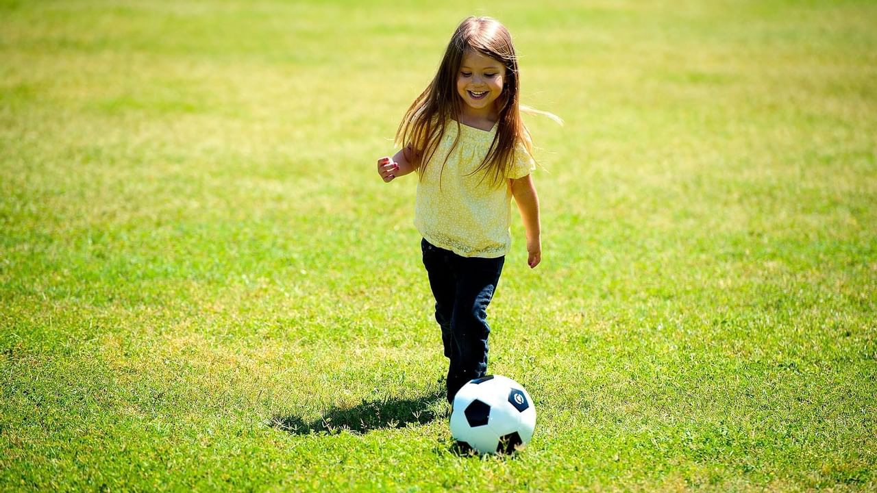 Girl in yellow playing soccer
