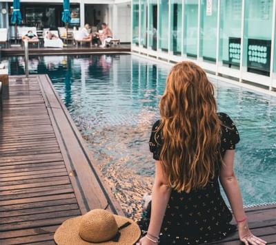 girl sitting on rooftop swimming pool in dream Thailand Bangkok