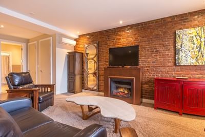 Fireplace by TV lounge area in Apartment 301 at Retro Suites Hotel