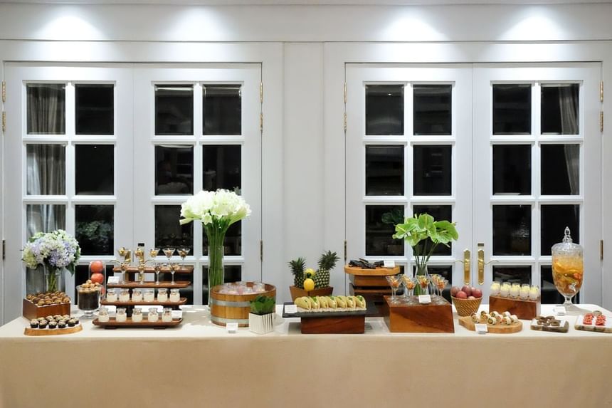 Arranged dessert table featuring an array of sweets, fruits, and floral centerpieces at Park Hyatt Saigon