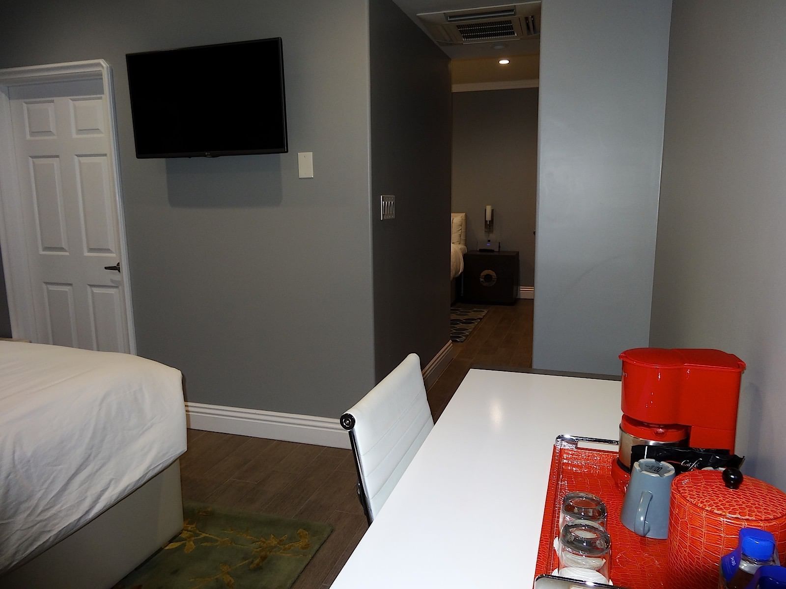 view of flat-screen tv and desk in family suite