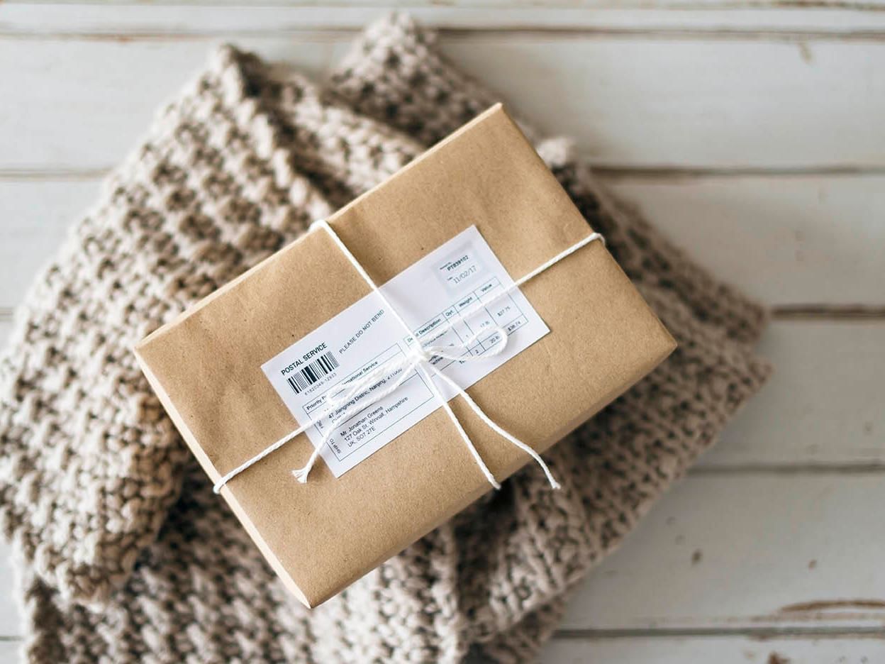 Closeup of a package wrapped in brown paper at DOT Hotels