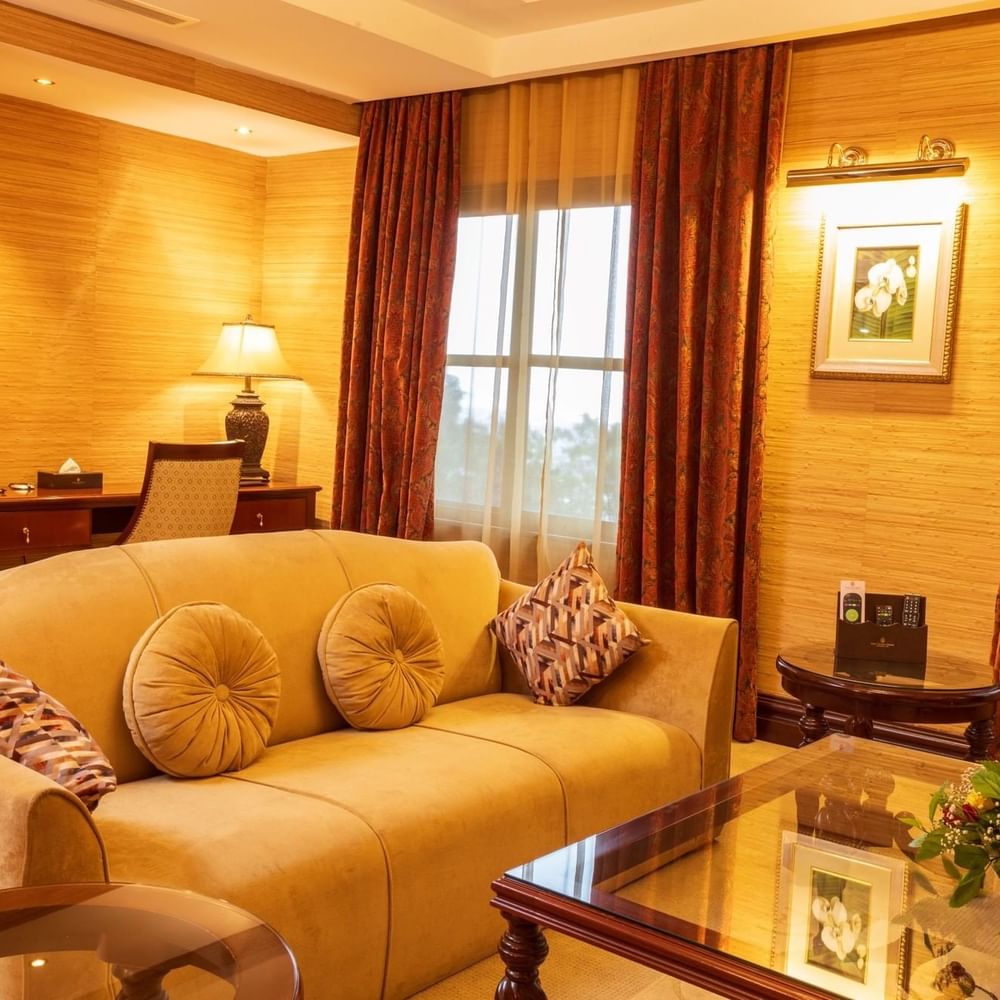 Elegant Presidential Suite living room with sofa and coffee table at Lake Victoria Serena Golf Resort & Spa in Kampala.