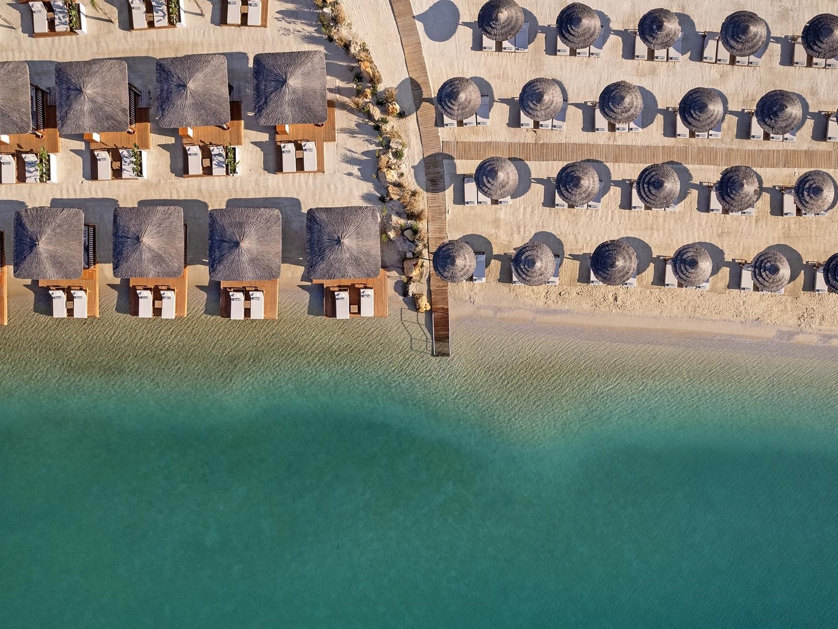 At Titanic Luxury Collection Bodrum, the beachfront luxury resort dazzles from above with tented umbrellas and sun loungers.