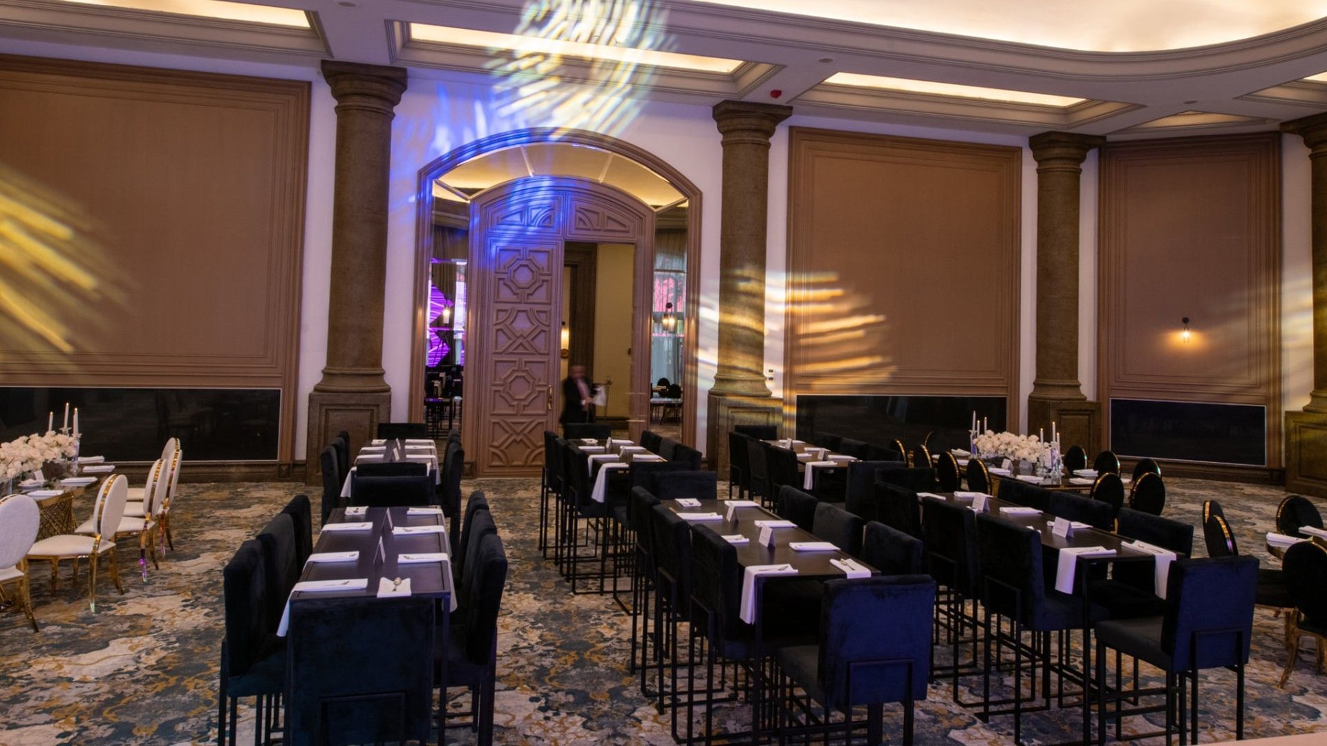 Gran Salon banquet setup featuring black velvet seating and ornate wooden door panels at Quinta Real Monterrey