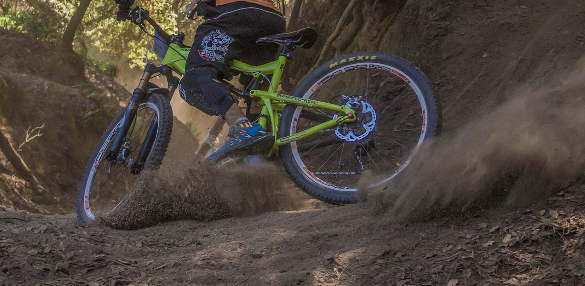 downhill mountain biker kicking up dust