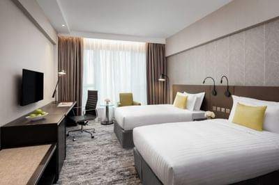 Work desk & lounge area by the bed in Deluxe Twin Room at Park Hotel Hong Kong