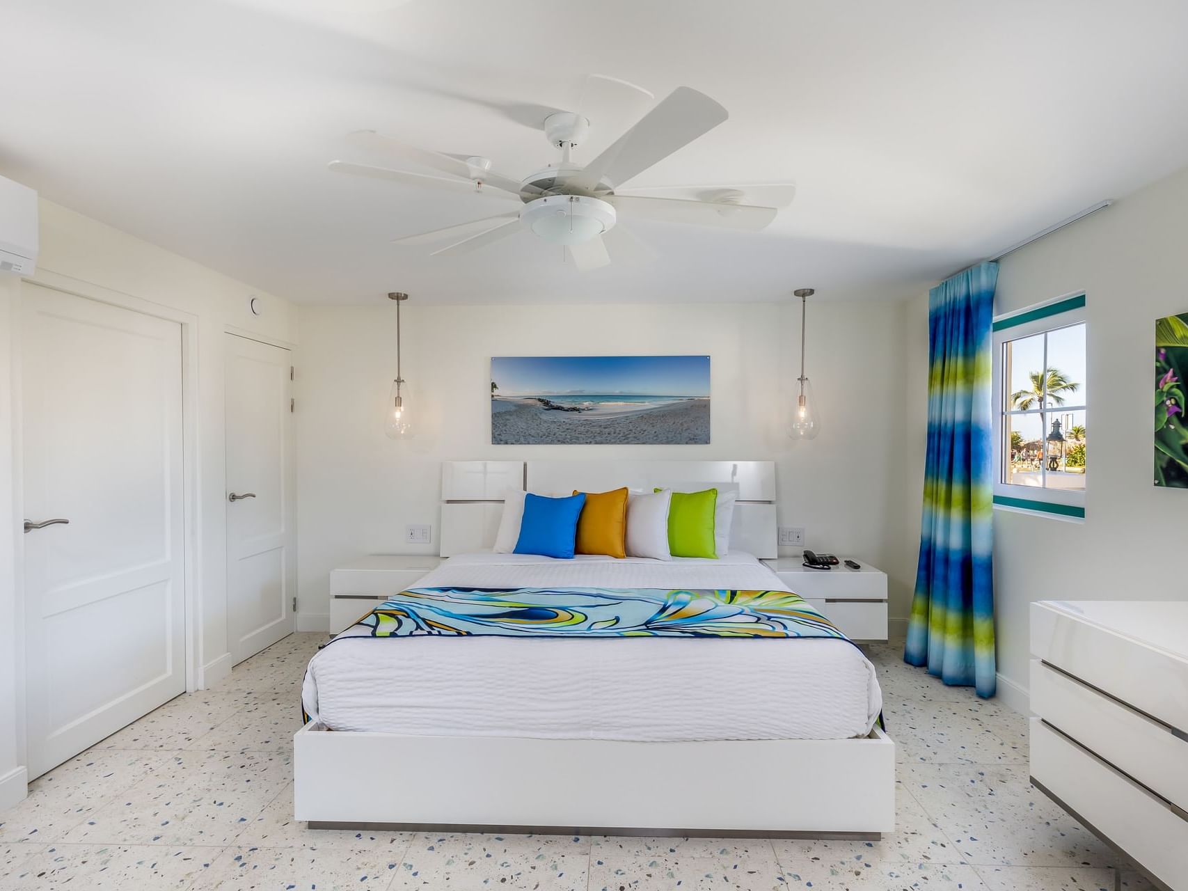 Cozy bedroom with king bed & modern interior in Honeymoon Suite at Passions on the Beach