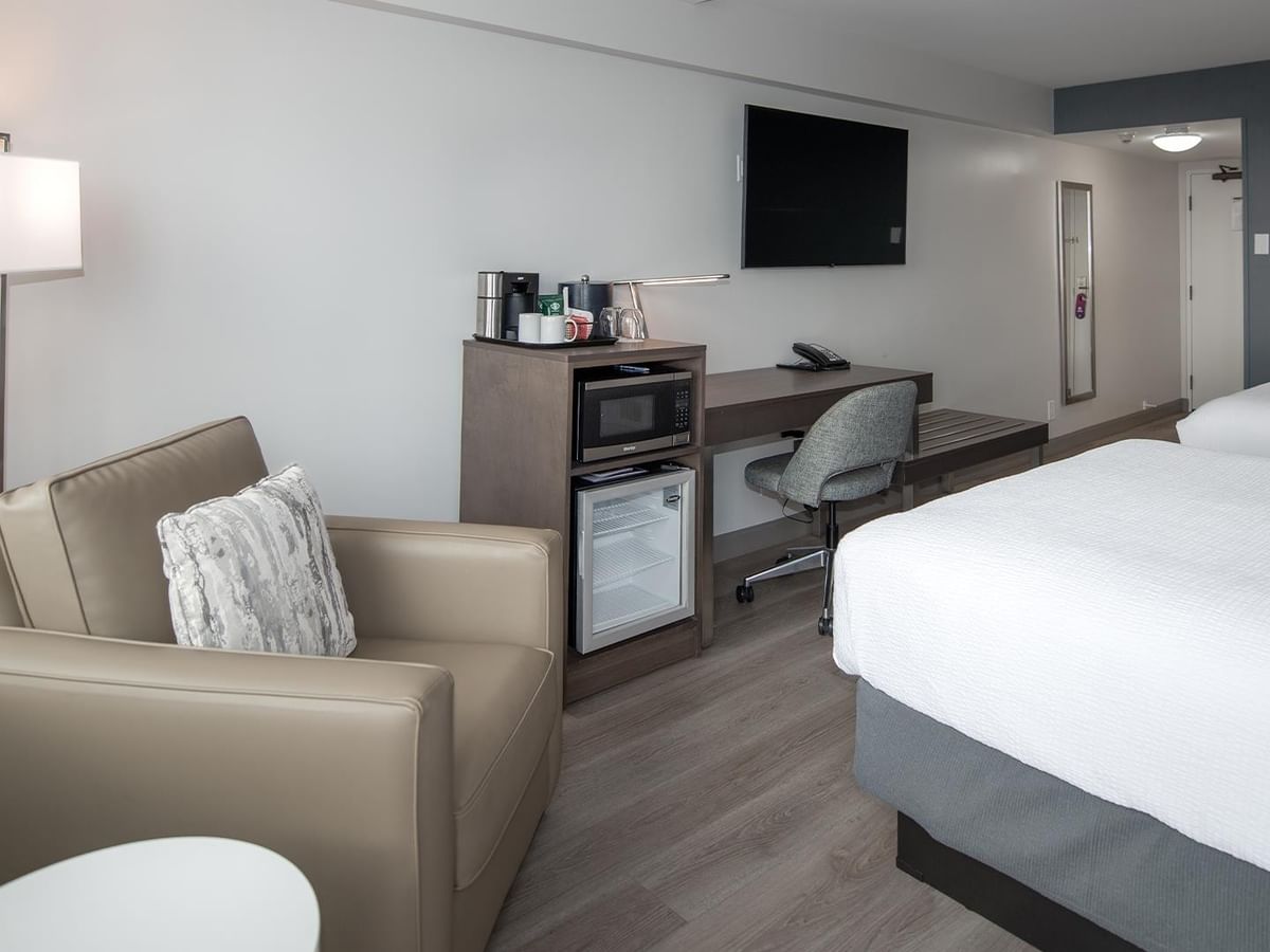 Coast Two Queens room with couch, desk, and two beds at Coast Bastion Hotel in Nanaimo.