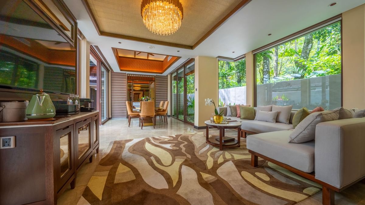 Spacious Grand Garden Villa living area with elegant chandelier, patterned rug, and lush garden views at The Banjaran Hotsprings Retreat