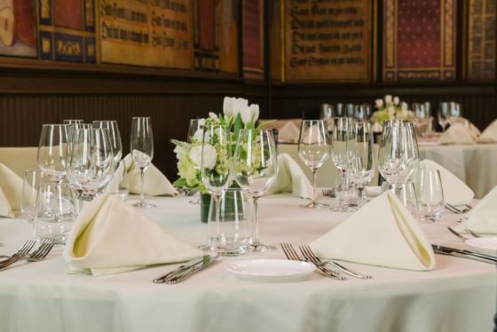 Banquet tables arranged with glasses & cutlery at The Abbey Inn